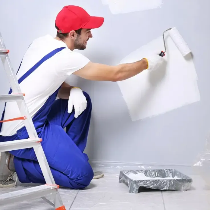Worker applying wall putty to prepare a wall for painting